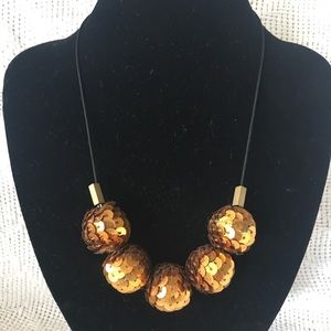 Necklace with beads in copper sequins.
